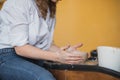 The female potter finished making a clay vase remove it from the potter`s wheel. Creating vase of white clay. Making Royalty Free Stock Photo