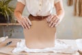 Female potter holds clay pancake, pottery workshop Royalty Free Stock Photo