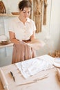 Female potter holds clay pancake, pottery workshop Royalty Free Stock Photo