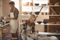 Female potter making pot in pottery workshop Royalty Free Stock Photo