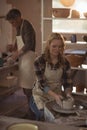 Female potter making pot in pottery workshop Royalty Free Stock Photo