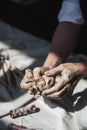 Female potter shaping piece of clay at the table. Woman making ceramic item. Pottery working, handmade and creative Royalty Free Stock Photo