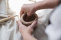 Female potter shaping piece of clay at the table. Woman making ceramic item. Pottery working, handmade and creative Royalty Free Stock Photo