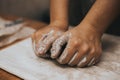 Female potter works with clay, craftsman hands close up, kneads and moistens the clay before work Royalty Free Stock Photo