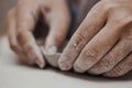 Female potter works with clay, craftsman hands close up, kneads and moistens the clay before work Royalty Free Stock Photo