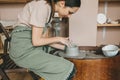 A female potter works in a clay workshop on a potter& x27;s wheel. The concept of a master class, a workshop Royalty Free Stock Photo