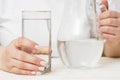 A female is pouring fresh, clear water from a jug into a glass. Health and diet concept. Clean water for good health Royalty Free Stock Photo