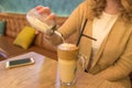 Close up of female putting sugar in her coffee in cafe Royalty Free Stock Photo