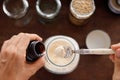 Female Pours Garlic Powder in Small Glass Jar. Shopping at Zero Waste Shop. No plastic Conscious Minimalism Lifestyle. Reduce