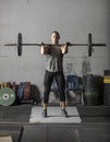 Female powerlifter doing a clean and jerk with heavy weights