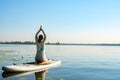 Female practicing yoga on a SUP board