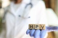Female practitioner hand holding wooden cubes with word hpv Royalty Free Stock Photo