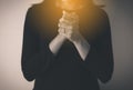 Female prayer hands clasped together,Woman with hand in praying position,Black and white toned Royalty Free Stock Photo