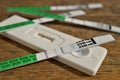 Female pregnancy test with two stripes as a positive confirmation of baby expectation