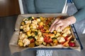 Female preparing colorful baked vegetables in kitchen Royalty Free Stock Photo