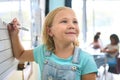 Female Primary Or Elementary School Student Writing On Whiteboard In Classroom Lesson Royalty Free Stock Photo