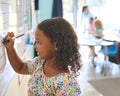 Female Primary Or Elementary School Student Writing On Whiteboard In Classroom Lesson Royalty Free Stock Photo