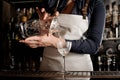 Female professional barman pouring fresh cocktail into a glass