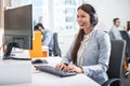 Female professional call center telesales agent using computer in customer care support service office with team. Royalty Free Stock Photo