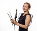 Female professional hairdresser with ploy. Elegant woman presents her hairdresser`s accessories. Hair styling and beauty