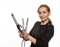 Female professional hairdresser with ploy. Elegant woman presents her hairdresser`s accessories. Hair styling and beauty