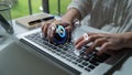 Female professional using laptop with DevOps symbols floating around, showcasing remote work and technology in a modern Royalty Free Stock Photo