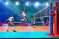 Female professional volleyball players in action on grand court