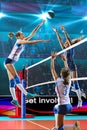 Female professional volleyball players in action on grand court Royalty Free Stock Photo