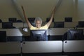 Female Professor Celebrating Victory In Computer Classroom