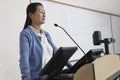 Female Professor Standing By Podium