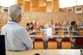 Female professor watching students at the lecture Royalty Free Stock Photo