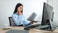 Female programmer reading document of database code to thinking for website development while using multiple Royalty Free Stock Photo
