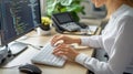 Female programmer types code on keyboard, screen displays syntax-highlighted script in modern office with green plant background Royalty Free Stock Photo