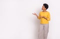 Female promoter with afro hairstyle demonstrating new product on copy space against white background