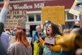 A Female protester shouting at a Black Lives Matter protest. Surrounded by other protesters who wear PPE Face Masks