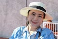 Portrait of female protrait in white hat and looking away.