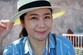 Portrait of female protrait in white hat and looking away.