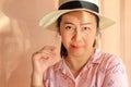 Female protrait in white hat and looking at camera, woman with pink shirt.