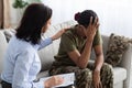 Female Psychologist Comforting Black Soldier Lady During Therapy Session In Office