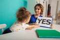 Female psychologist counseling little girl in the cabinet.