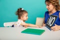 Female psychologist counseling little girl in the cabinet.