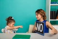 Female psychologist counseling little girl in the cabinet.