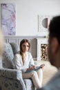 Female psychologist having therapeutic session with young couple on a sofa in office Royalty Free Stock Photo