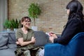 Woman psychologist having therapy session with middle aged military female Royalty Free Stock Photo