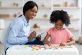 Female psychologist working with little girl at office Royalty Free Stock Photo