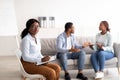 Female psychologist and young black couple having conflict during marital therapy at office, copy space Royalty Free Stock Photo