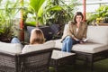 A female psychologists therapy session with a client indoors, sitting on the sofa