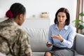 Female Psychotherapist Talking To Black Military Lady During Therapy Session In Office Royalty Free Stock Photo