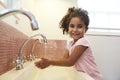 Female Pupil At Montessori School Washing Hands In Washroom Royalty Free Stock Photo