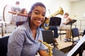 Female Pupil Playing Saxophone In High School Orchestra